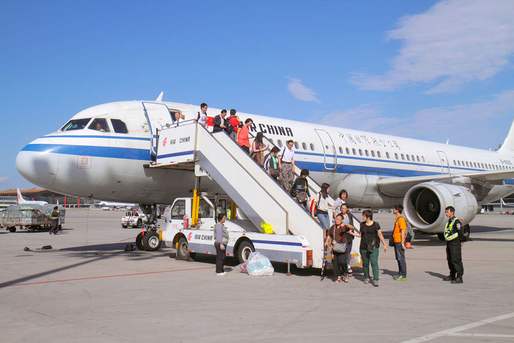 Passengers Disembark From a Flight at Capital International Airport of Beijing China, Asia - Cheapest Time